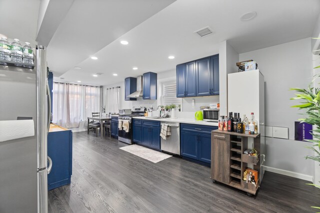 225 Freeman Ave, Jersey City, NJ 07306 - kitchen with visible vents, blue cabinetry, dark wood-style floors, appliances with stainless steel finishes, and wall chimney exhaust hood