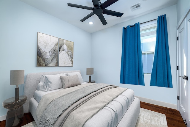 bedroom with ceiling fan and dark hardwood / wood-style floors