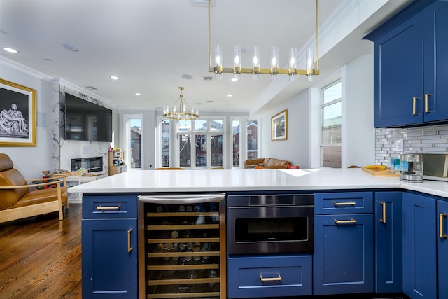 kitchen featuring backsplash, wine cooler, blue cabinets, and ornamental molding