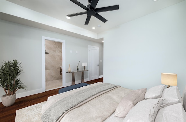 bedroom with ceiling fan, dark hardwood / wood-style flooring, and connected bathroom