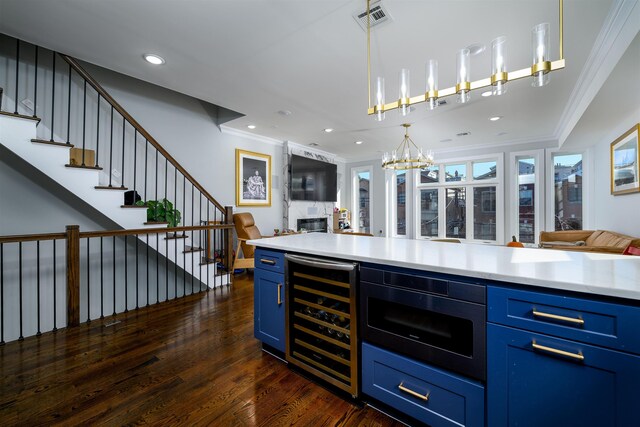 bar with crown molding, blue cabinets, a fireplace, and wine cooler