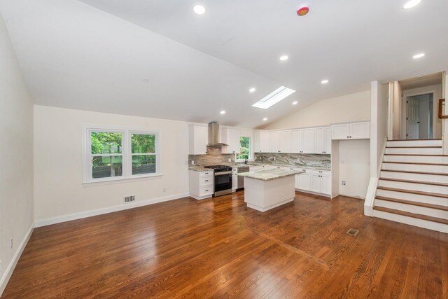 44 Grover Dr, Wayne, NJ 07470 - kitchen with appliances with stainless steel finishes, lofted ceiling, tasteful backsplash, wall chimney exhaust hood, and white cabinets