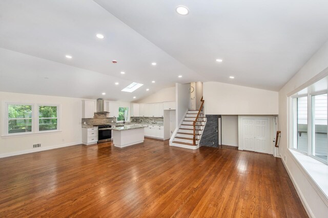 44 Grover Dr, Wayne, NJ 07470 - unfurnished living room featuring lofted ceiling, plenty of natural light, dark wood-style flooring, stairs, and recessed lighting