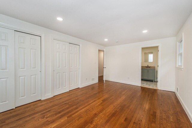 44 Grover Dr, Wayne, NJ 07470 - unfurnished bedroom with multiple closets, wood finished floors, recessed lighting, and ensuite bathroom