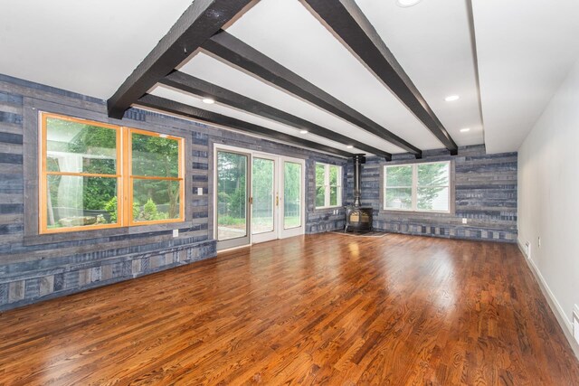 44 Grover Dr, Wayne, NJ 07470 - unfurnished living room with a wood stove, wood finished floors, beam ceiling, and wood walls
