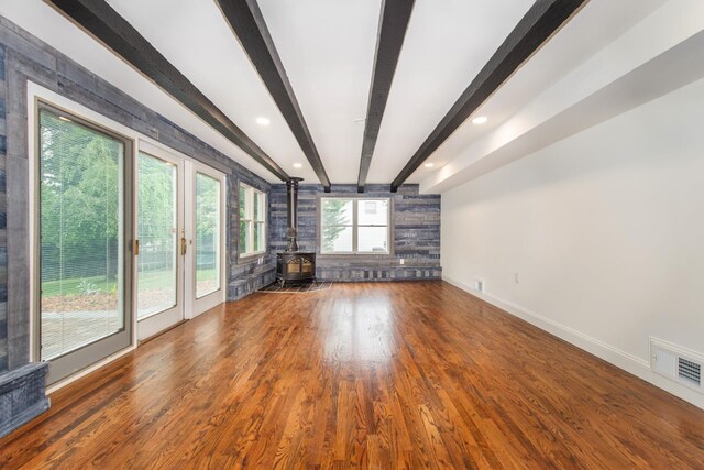 44 Grover Dr, Wayne, NJ 07470 - unfurnished living room with a wood stove, beamed ceiling, and wood finished floors