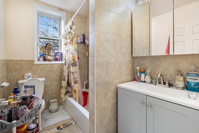 full bath featuring shower / tub combo, vanity, and tile walls