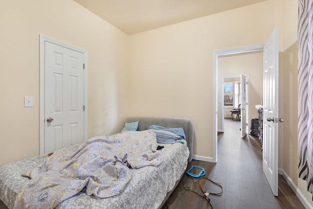 bedroom featuring baseboards and wood finished floors