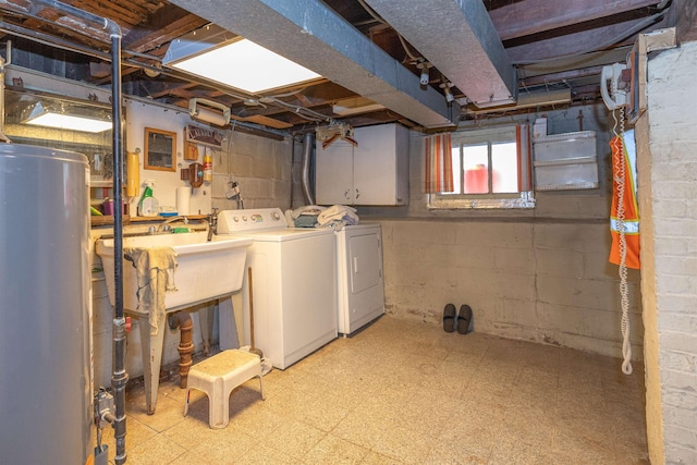 basement featuring water heater, sink, and washer and clothes dryer