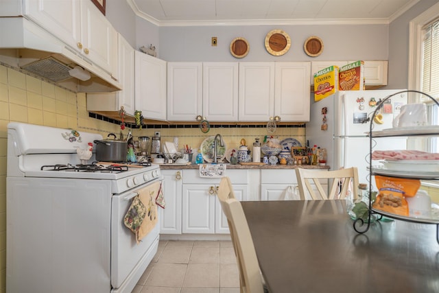 kitchen featuring light tile patterned floors, white cabinets, white appliances, and decorative backsplash