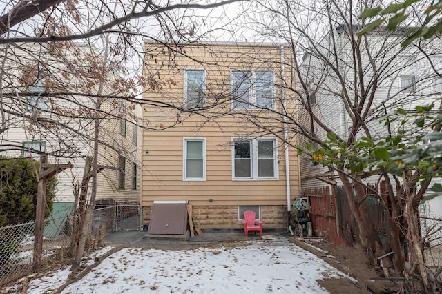 view of snow covered rear of property