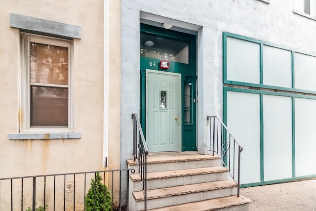 view of exterior entry featuring stucco siding