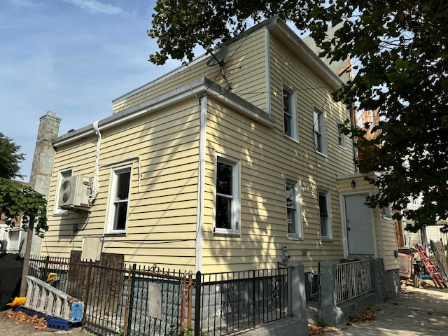 view of side of property with ac unit