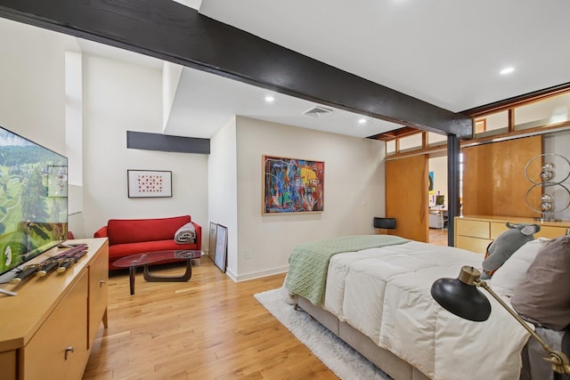 bedroom with baseboards, recessed lighting, light wood-style flooring, and visible vents