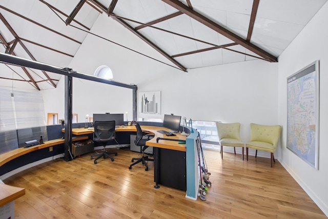 home office featuring high vaulted ceiling, baseboards, beamed ceiling, and wood finished floors