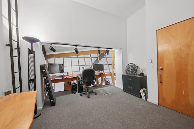 carpeted home office featuring baseboards