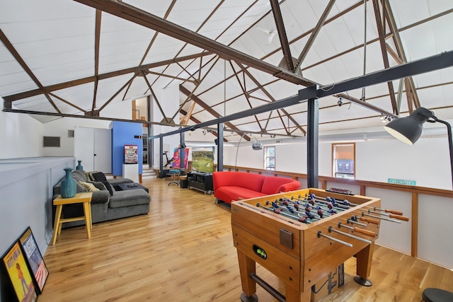 game room with wood finished floors and lofted ceiling