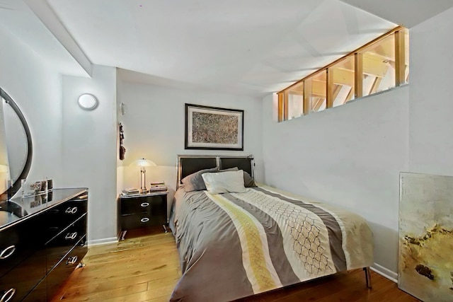 bedroom featuring baseboards and light wood-style floors