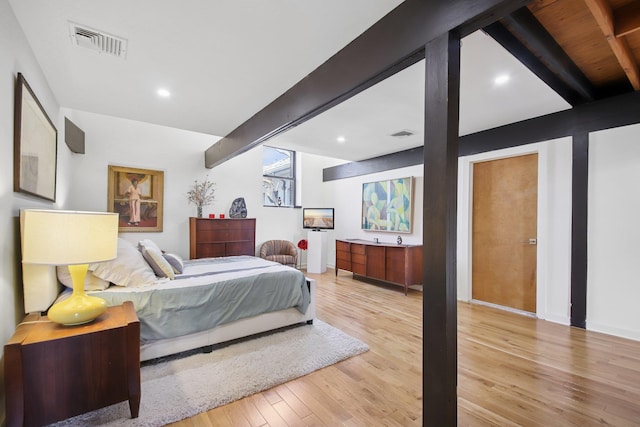 bedroom with visible vents, recessed lighting, wood finished floors, and beamed ceiling