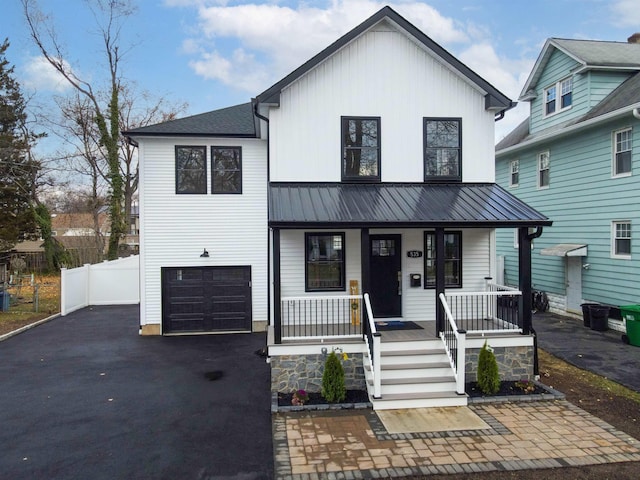 view of front of home with a porch and a garage