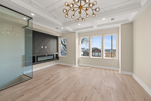 unfurnished room featuring coffered ceiling, wood finished floors, visible vents, baseboards, and crown molding