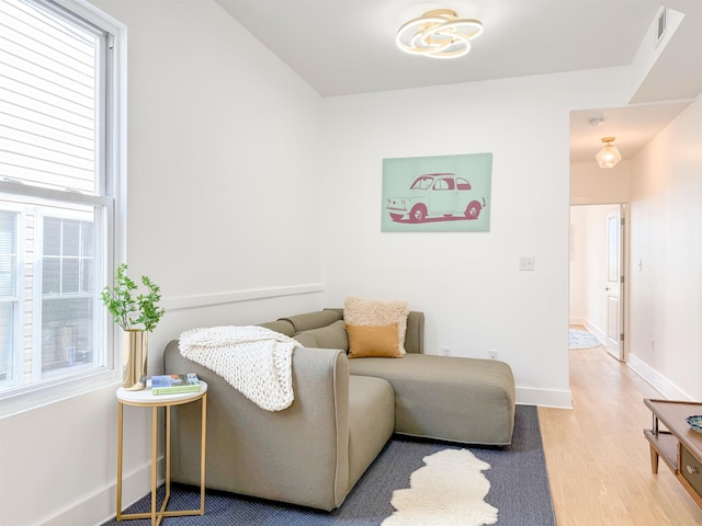 living room with baseboards, a healthy amount of sunlight, and wood finished floors