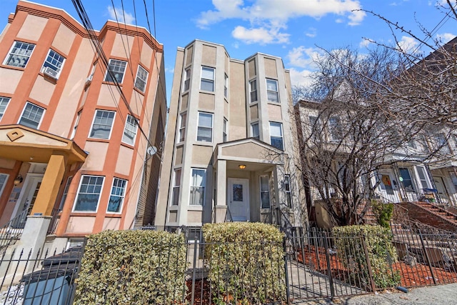 view of building exterior featuring a fenced front yard