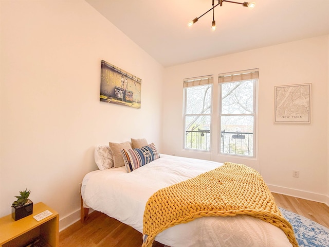 bedroom with wood finished floors and baseboards