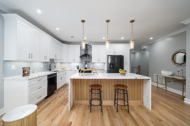 kitchen with wall chimney range hood, refrigerator with ice dispenser, white cabinets, black dishwasher, and a kitchen island