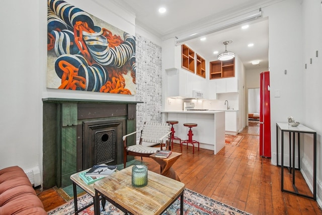237 3rd St Unit 1, Jersey City, NJ 07302 - living room featuring hardwood / wood-style flooring, a fireplace, recessed lighting, and crown molding