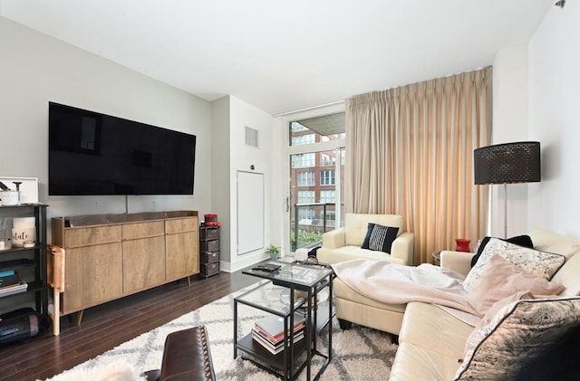 living area featuring visible vents and dark wood-style flooring