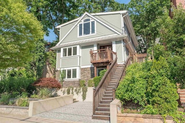 238 Undercliff Ave, Edgewater, NJ 07020 - view of front of house with stairs, stone siding, and a standing seam roof
