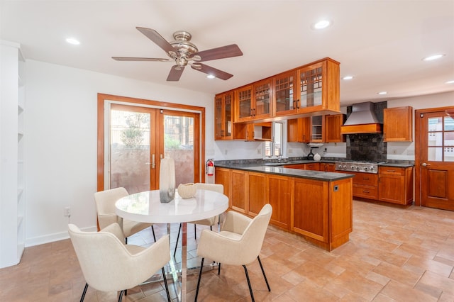 238 Undercliff Ave, Edgewater, NJ 07020 - kitchen with premium range hood, dark countertops, brown cabinets, stainless steel gas cooktop, and recessed lighting