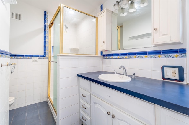 238 Undercliff Ave, Edgewater, NJ 07020 - full bathroom with tile walls, a stall shower, vanity, tile patterned floors, and wainscoting