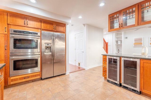 238 Undercliff Ave, Edgewater, NJ 07020 - kitchen with stainless steel appliances, beverage cooler, recessed lighting, and brown cabinets
