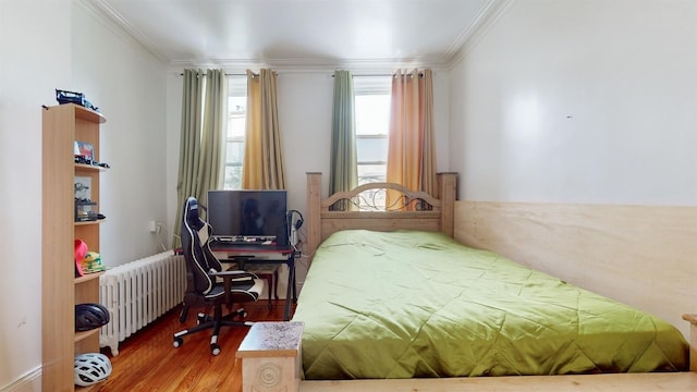 bedroom with wood-type flooring, radiator heating unit, and ornamental molding