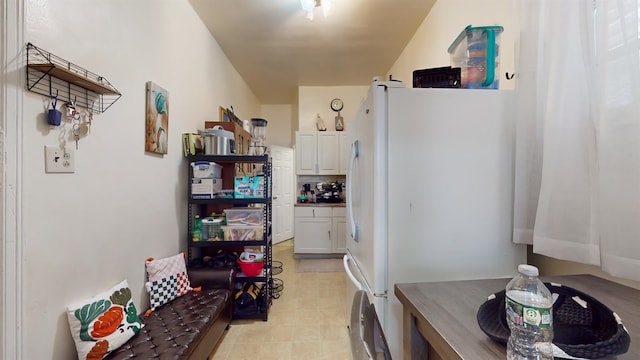 kitchen featuring white cabinetry and white fridge