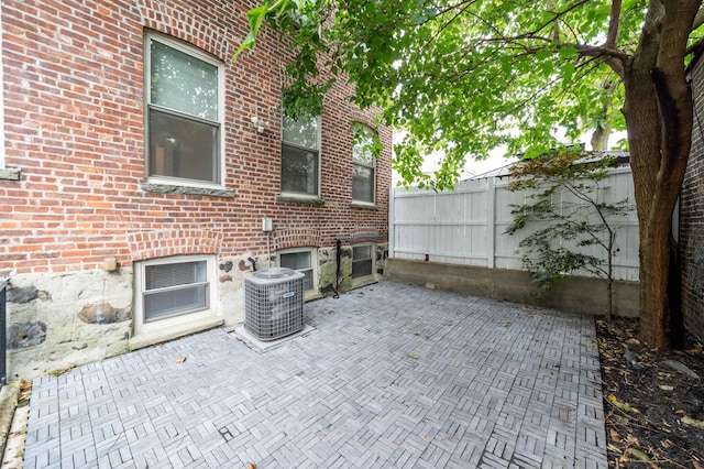 view of patio with central AC and fence