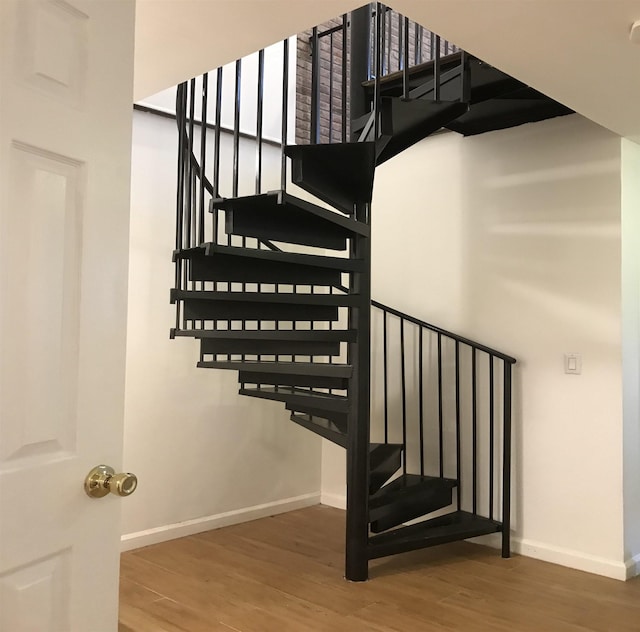 stairs featuring baseboards and wood finished floors