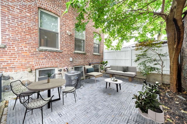 view of patio featuring fence and an outdoor hangout area