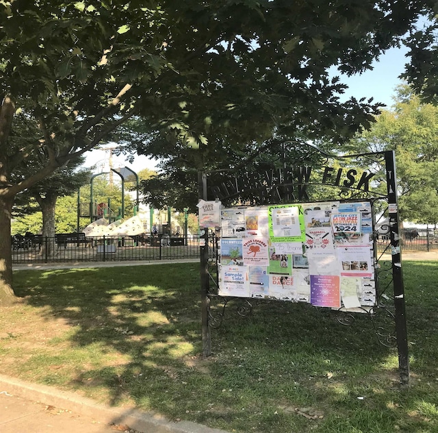 view of property's community featuring fence and a lawn