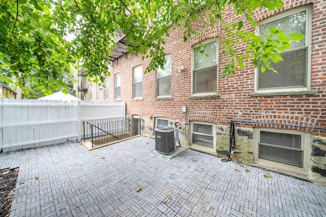 view of patio / terrace featuring fence and central air condition unit