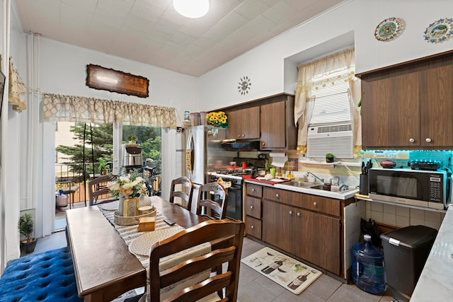 58 Booraem Ave, Jersey City, NJ 07307 - kitchen featuring stainless steel appliances, a sink, light countertops, and backsplash