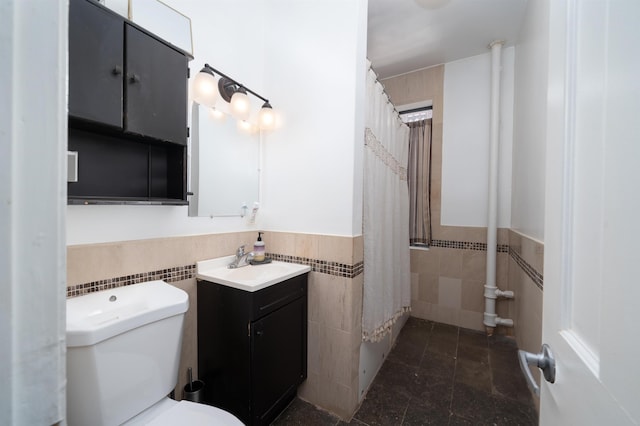 275 Harrison Ave Unit D8, Jersey City, NJ 07304 - bathroom with tile walls, vanity, curtained shower, and wainscoting