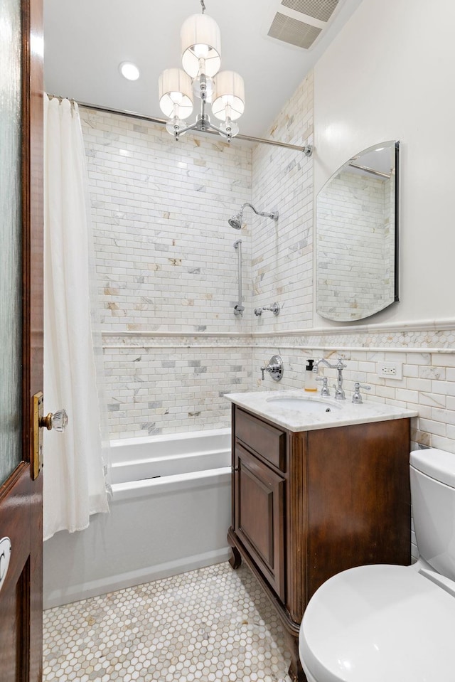 908 Garden St Unit 1, Hoboken, NJ 07030 - bathroom featuring shower / bath combination with curtain, toilet, vanity, a chandelier, and tile walls