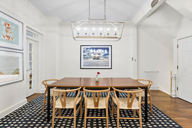 908 Garden St Unit 1, Hoboken, NJ 07030 - dining area with a chandelier, baseboards, radiator, dark wood-style flooring, and crown molding