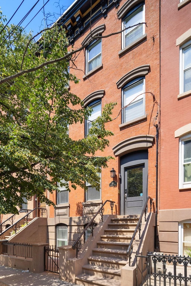 908 Garden St Unit 1, Hoboken, NJ 07030 - view of front facade with brick siding and a fenced front yard