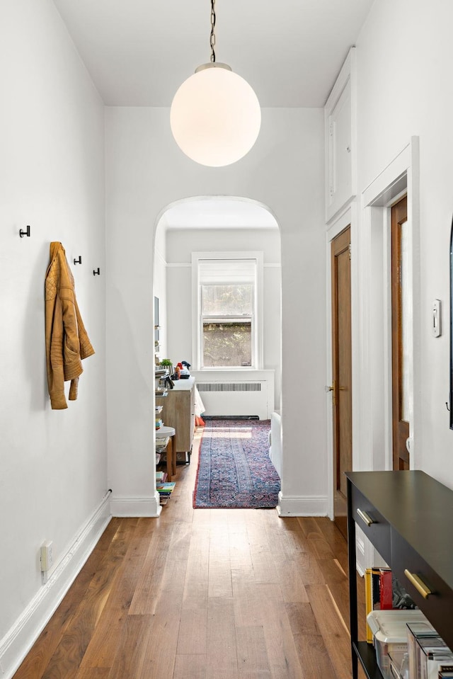908 Garden St Unit 1, Hoboken, NJ 07030 - hall featuring radiator, hardwood / wood-style floors, arched walkways, and baseboards