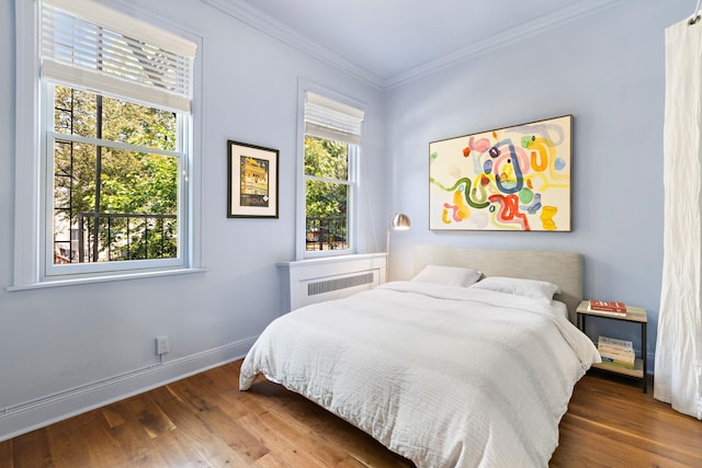 908 Garden St Unit 1, Hoboken, NJ 07030 - bedroom featuring wood finished floors, radiator, crown molding, and baseboards