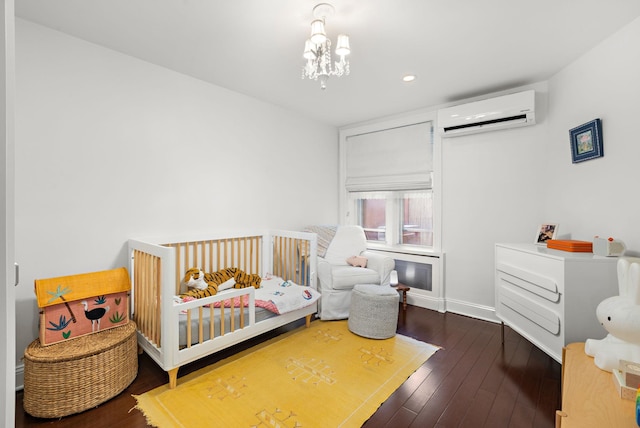 908 Garden St Unit 1, Hoboken, NJ 07030 - bedroom with a wall unit AC, hardwood / wood-style flooring, a chandelier, recessed lighting, and baseboards